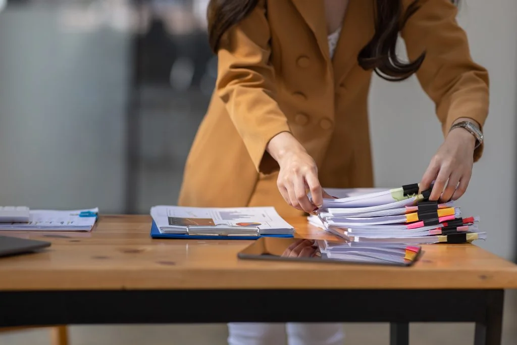 Young business woman gathering documents